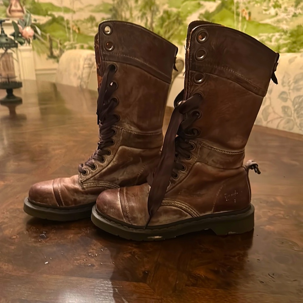 Tall Doc Martens with ribbon laces.